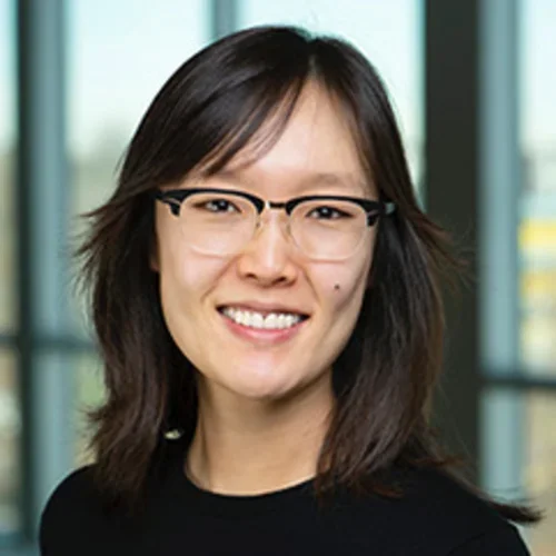andrea oh wearing glasses and a black shirt