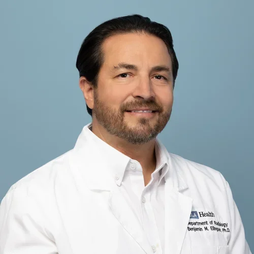 ben ellingson in a white lab coat on a light bluish gray background