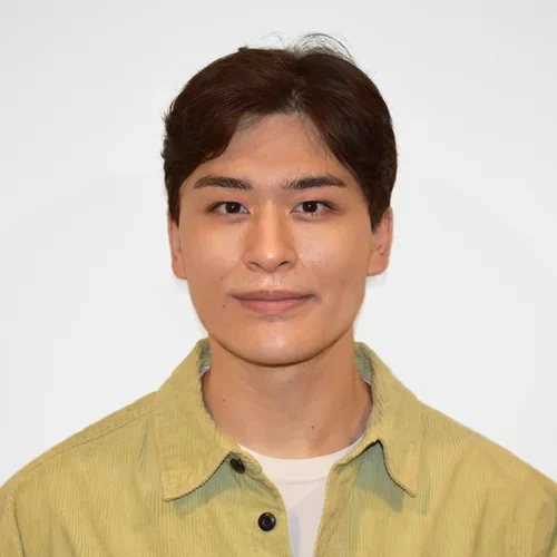 joshua genender in a yellow button up shirt against a white background