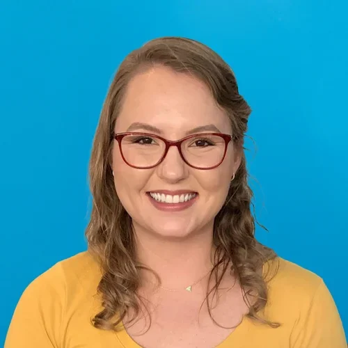 emma stackpole wearing a yellow shirt on a bright blue background