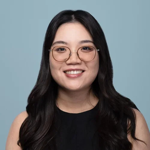 zexi wang wearing glasses on a light bluish gray background