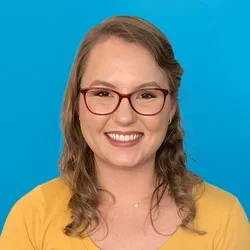 emma stackpole wearing a yellow shirt on a bright blue background