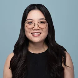 zexi wang wearing glasses on a light bluish gray background
